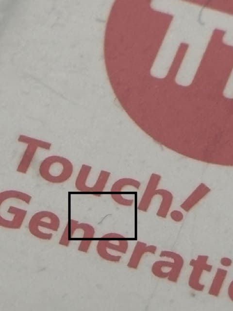 Debris visible under the plastic seal of a resealed Nintendo DS game