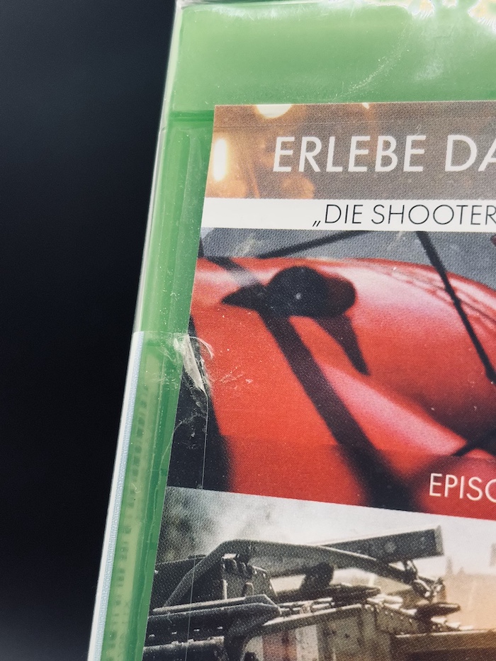 Damaged Xbox security sticker visible under an undamaged outer foil on Battlefield 1